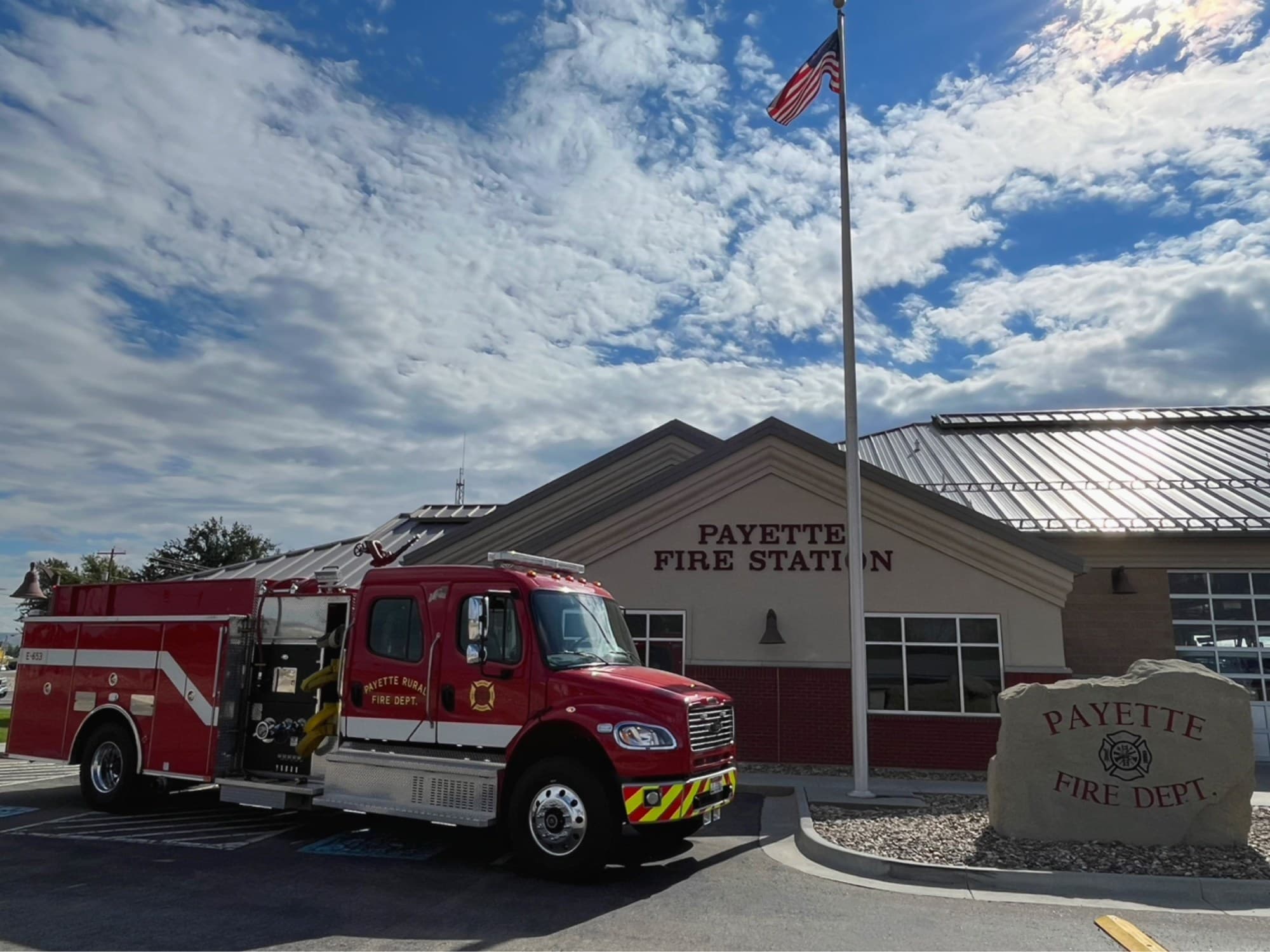 A Payette fire engine parked outside the station beneath the American flag