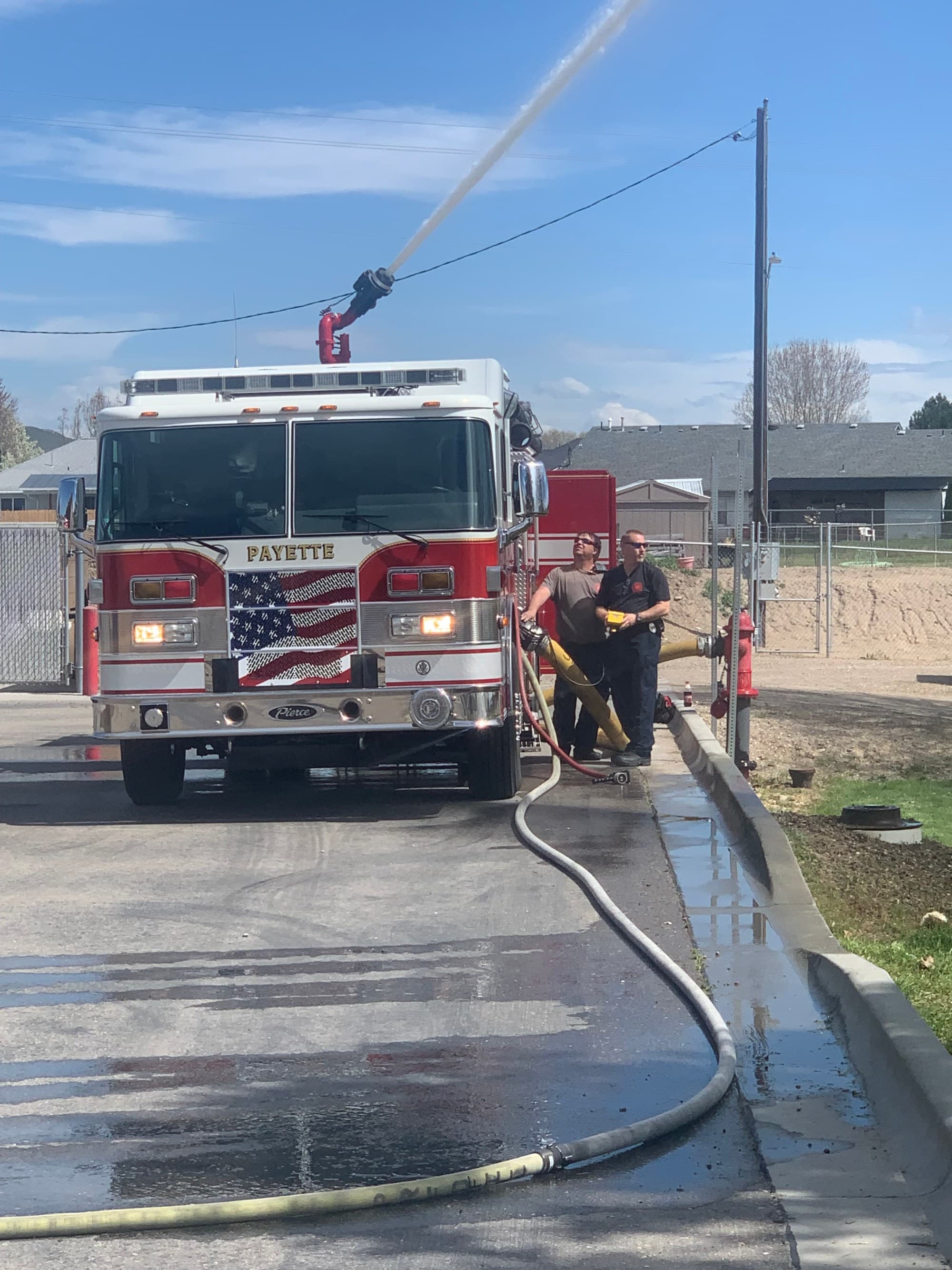 Engine 601 working a scene with charged hose lines on the street